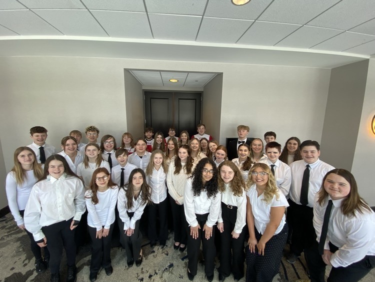 students posing in white shirts