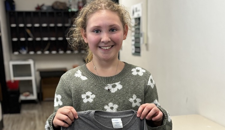 girl posing holding Ohio county shirt