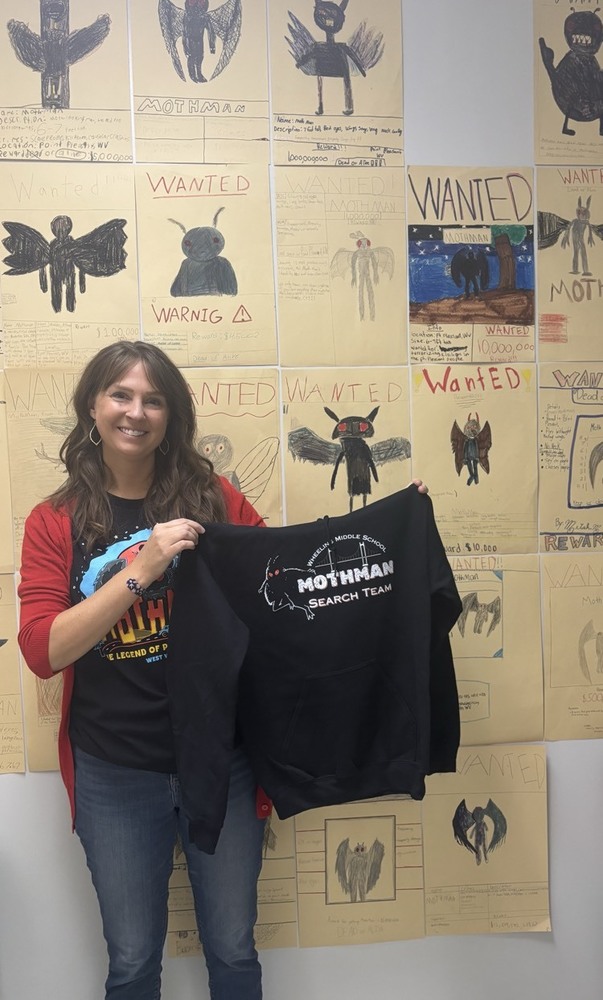 teacher holding sweatshirt