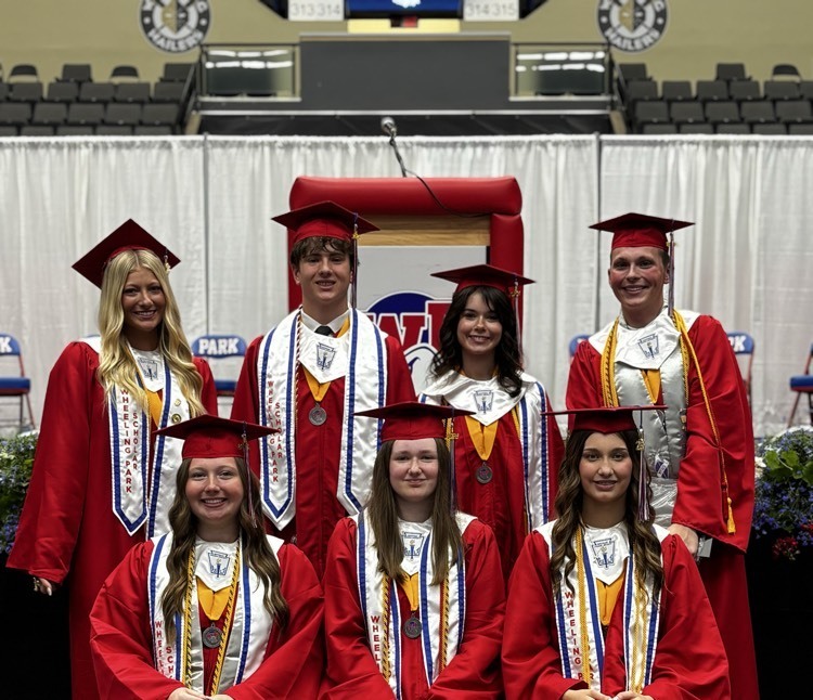 students in graduation robes smiling