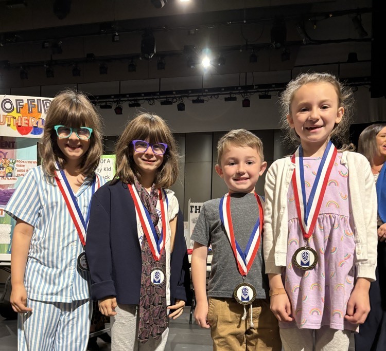 students posing with medals