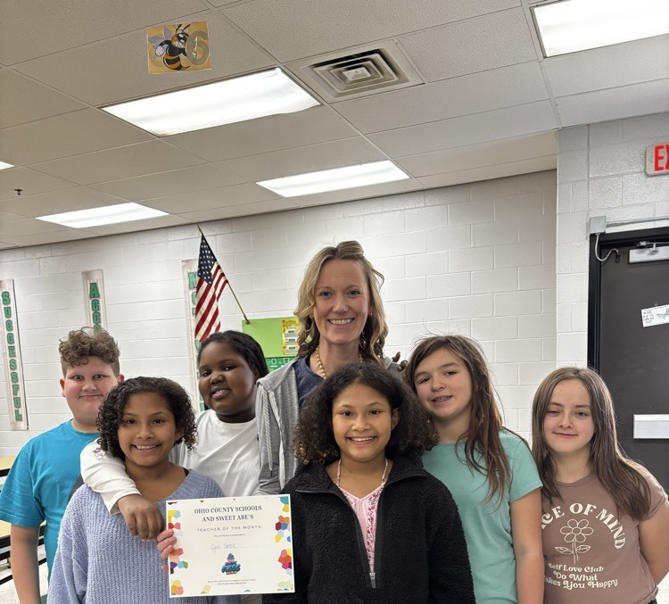teacher standing with students 