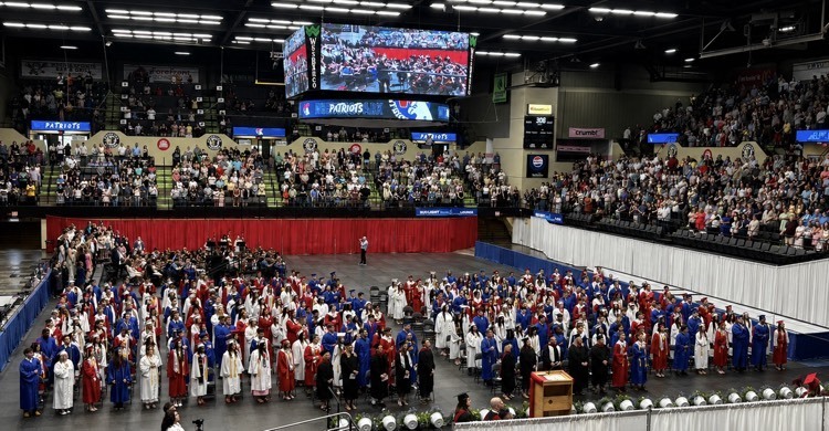 graduates in red, white, and blue robes 
