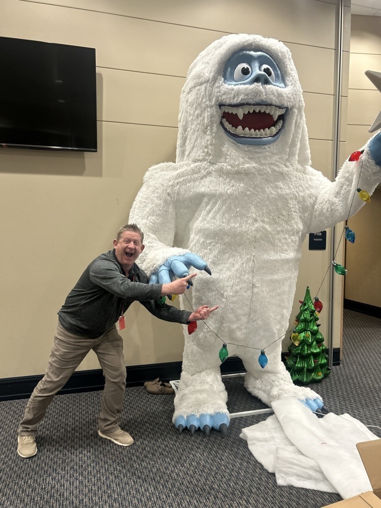 man standing with giant snow man