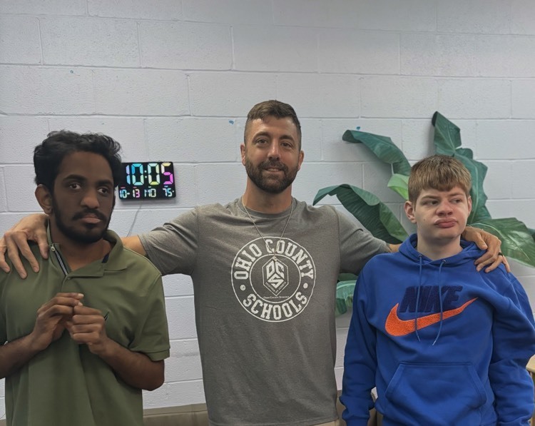 teacher posing with students