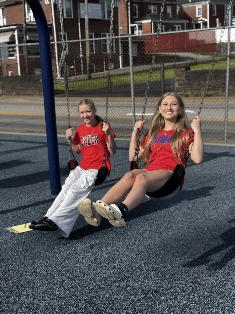 girls swinging on swing