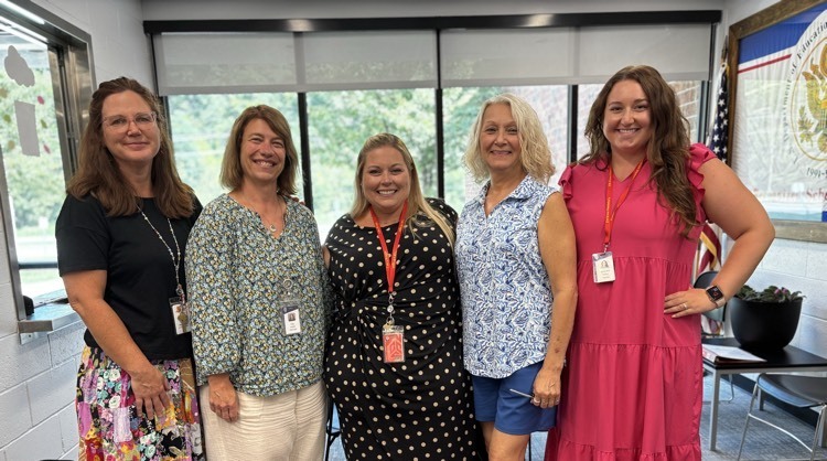 teachers posing and smiling in group
