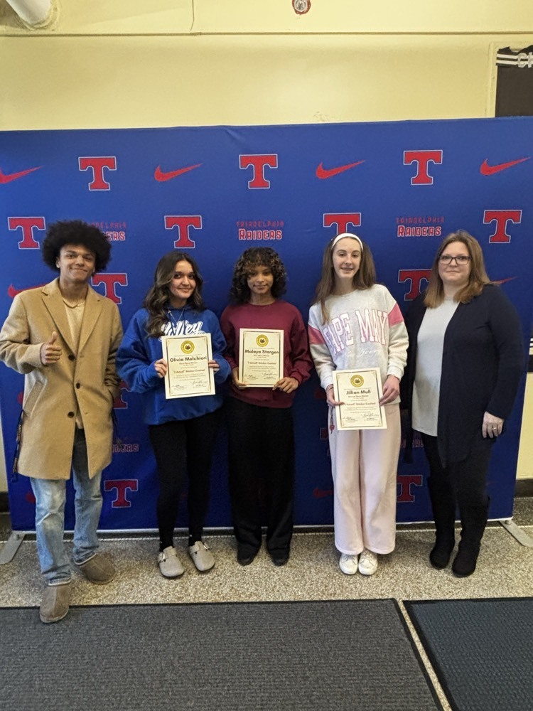 students posing holding signs
