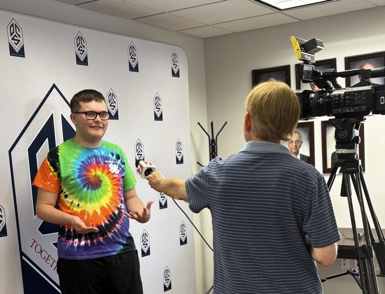 student smiling while being interviewed 