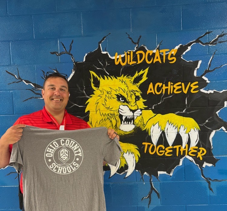 man posing holding Ohio County Schools shirt