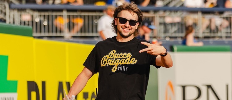 man smiling and posing on baseball field