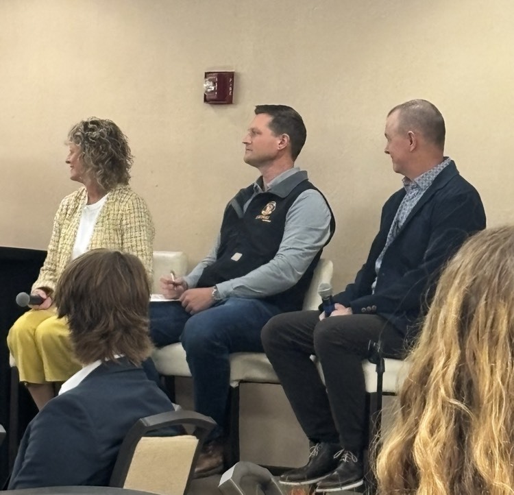 Men and woman speaking on panel discussion