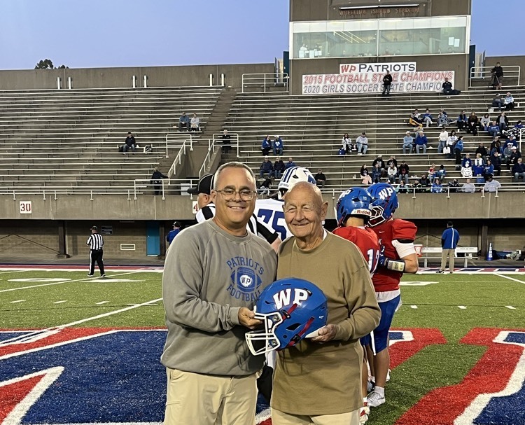 men posing with football helmet