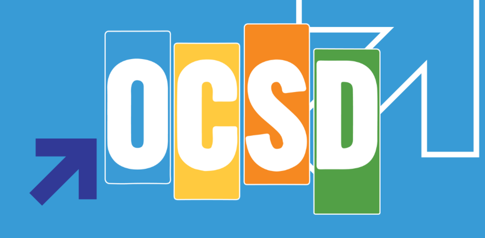 OCSD Logo - A clean, modern logo on a blue background features the white letters “OCSD” in colorful rounded rectangles, accented by an upward arrow and rising line to convey growth and progress.