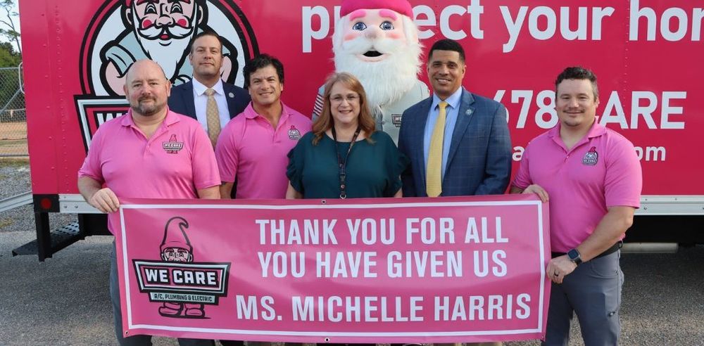 Ms. Harris picutred with Superintendent Chambers, School Board member Parker Destin, and the We Care team