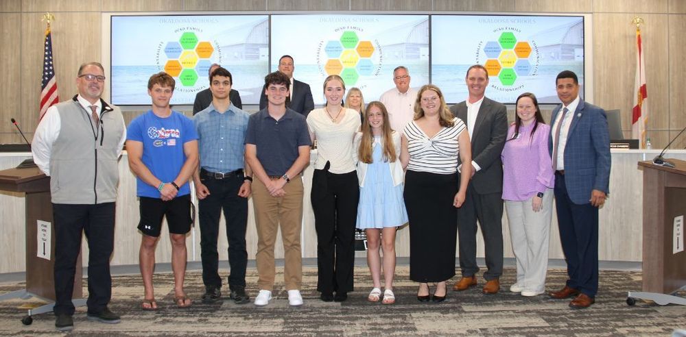 YLC members, Wesley Gieringer (Collegiate), Lester Hammond (Collegiate), Cameron Ross (Rocky Bayou), Ava Mullins (Baker), Abbigail Heck (Choctaw), Hadley Fay (Niceville), are pictured with Assistant Superintendent John Spolski, Superintendent Marcus Chambers, Commissioner Drew Palmer, and Ms. Allison Sullivan.