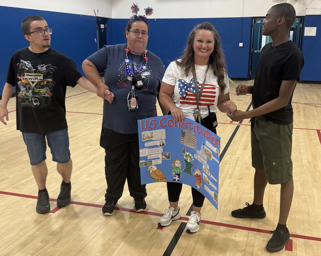 Students and teachers hold a U.S. Constitution presentation board during the America250 event.
