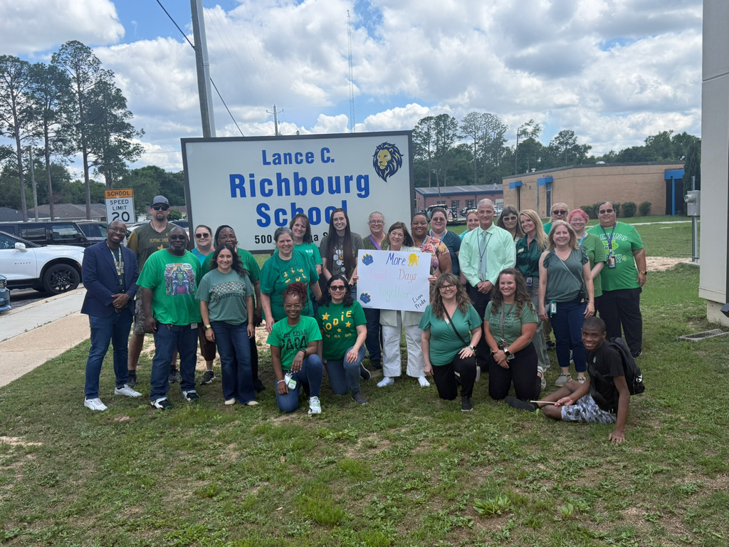Richbourg /Best Chance School staff members and students wearing green gather outside near the school sign to recognize Mental Health Awareness Month and promote mental wellness and positivity.