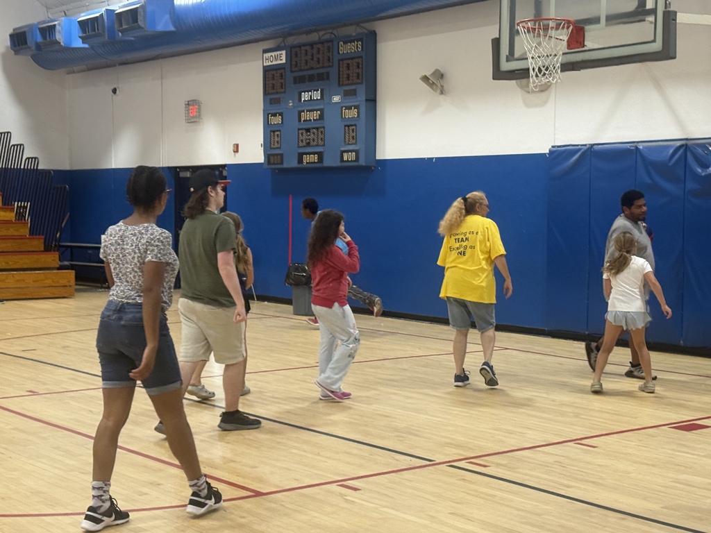 Students and staff members participate in a basketball game inside the Richbourg School gymnasium during the annual staff versus student event.