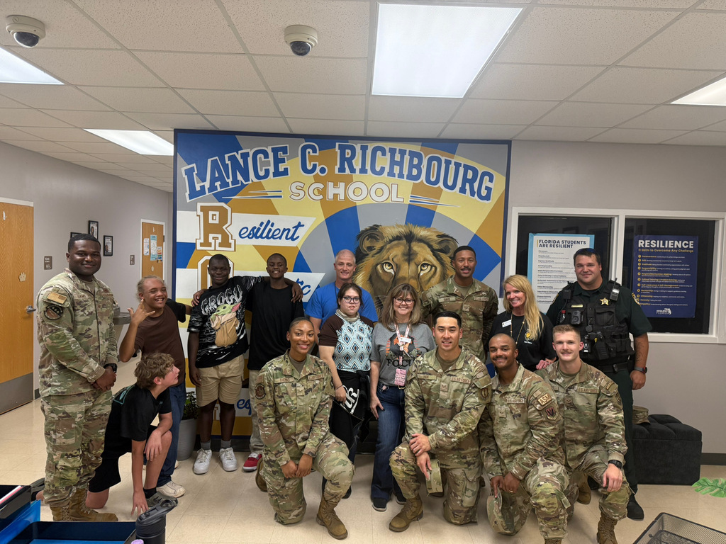 “Richbourg students and staff pose for a group photo with members of the Eglin Air Force Base Honor Guard following their visit to the school.”
