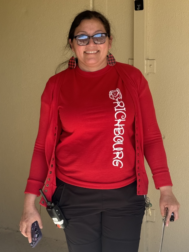 A staff member dressed in red stands outdoors during Red Ribbon Spirit Day, showing support for healthy, drug-free choices and school spirit.