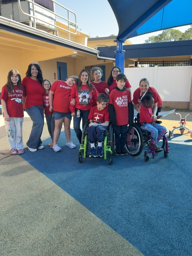 Students and staff wearing red pose together outdoors during Red Ribbon Spirit Day, celebrating school spirit and healthy, drug-free choices