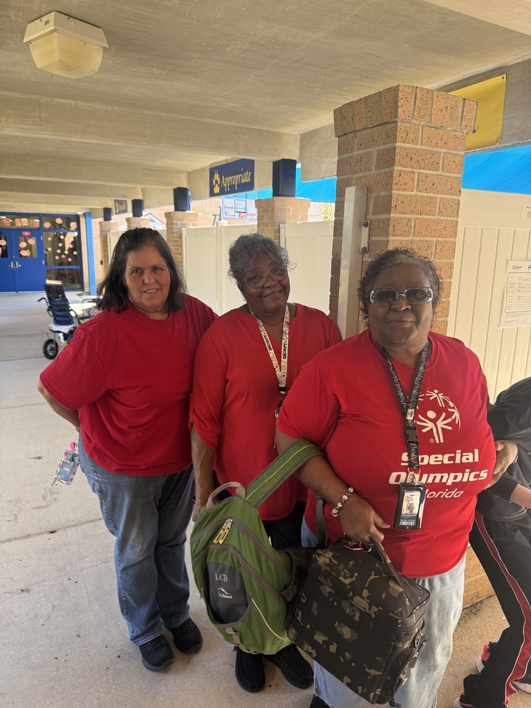 Three staff members wearing red pose together outside during Red Ribbon Spirit Day, showing support for healthy, drug-free choices and school community spirit.