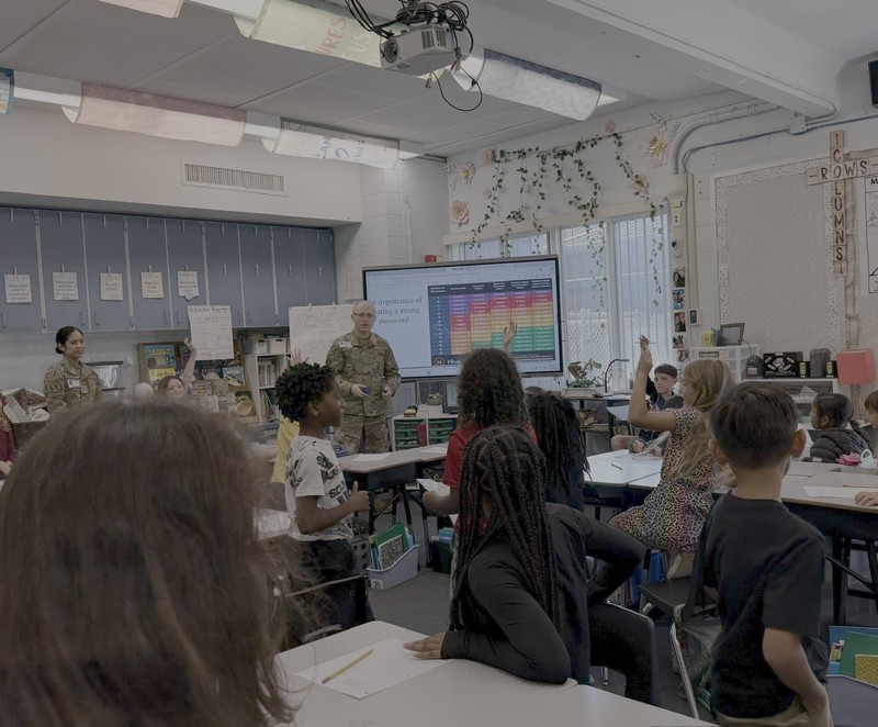 Members of the 96th Communications Squadron presenting a Cyber Security course to students