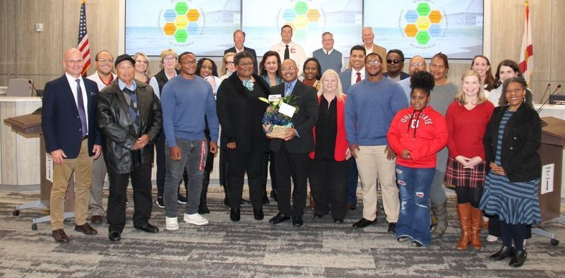 Steve Chatman, Director of Human Resources, at School Board meeting with family, friends, SB, and peers.