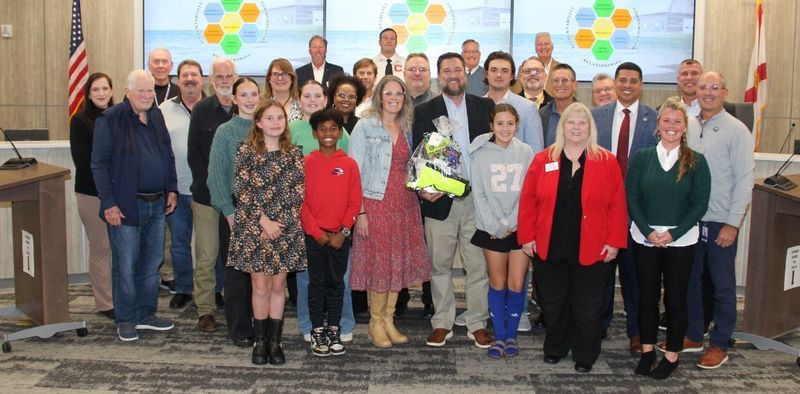 Dustin Keith, Facilities Program Director, at SB meeting with family, friends, SB, and peers.