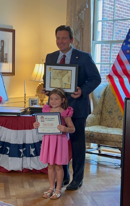 Destin Elementary School kindergartner Claire Grelle with Gov DeSantis