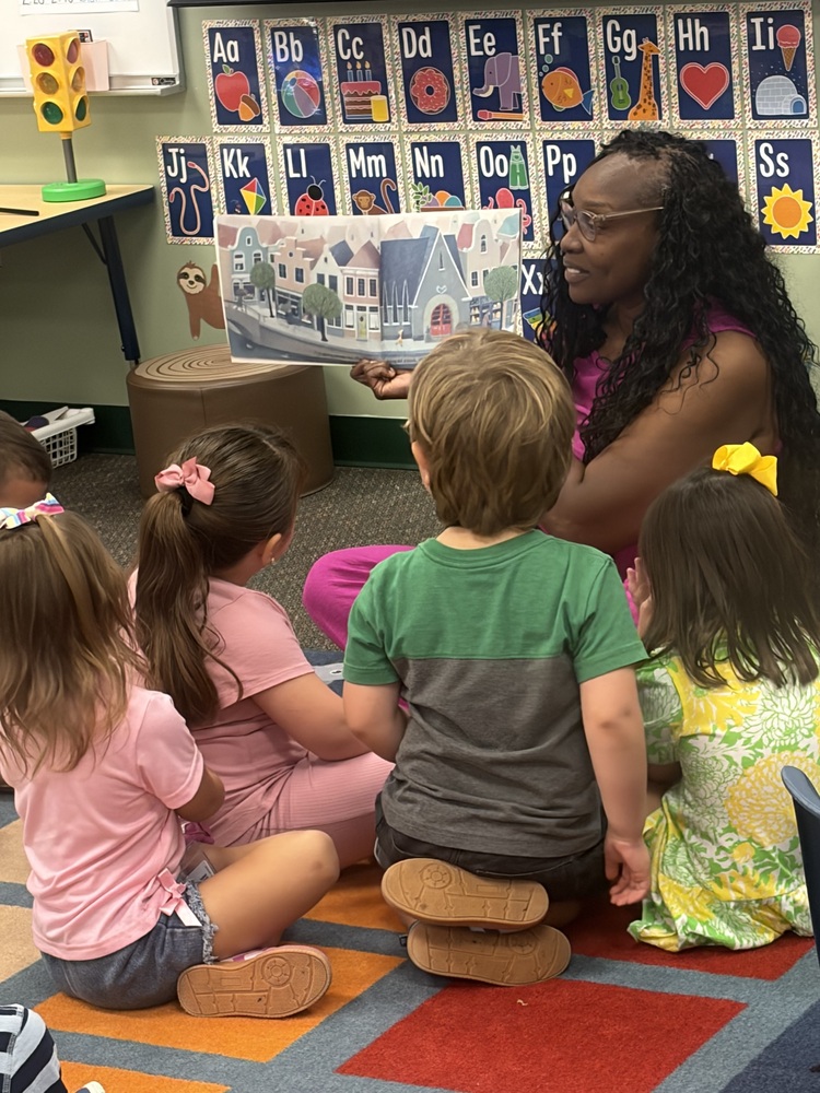 Children reading with teacher