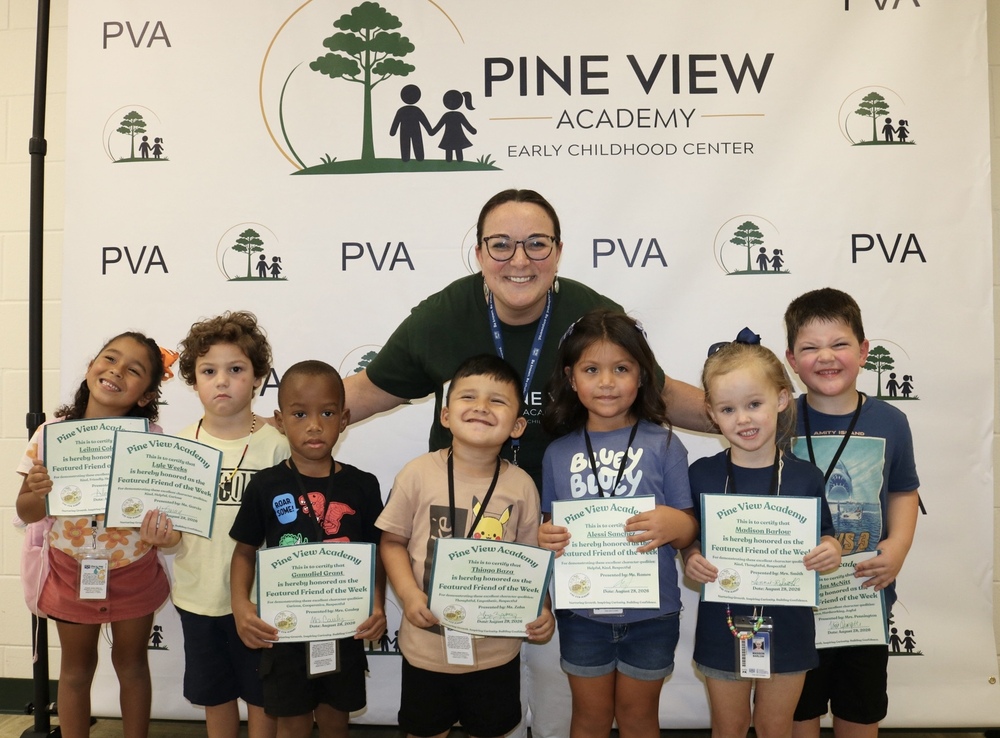 group of students of the week with principal holding certificates