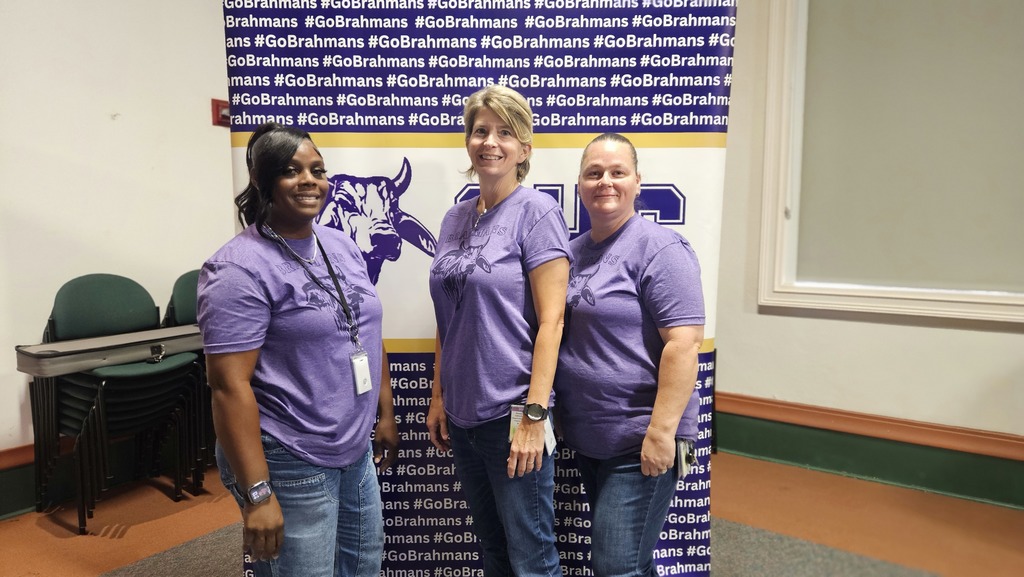 three cafeteria ladies infront of brahman backdrop