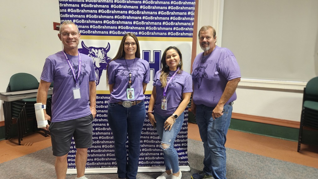 four elective class teachers wearing purple shirt Infront of brahman backdrop