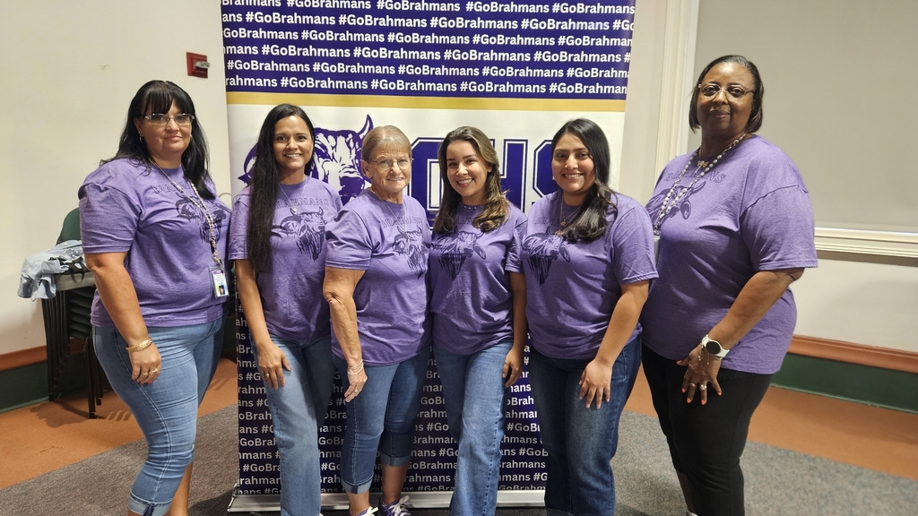 six female support staff wearing the same purple brahman shirt