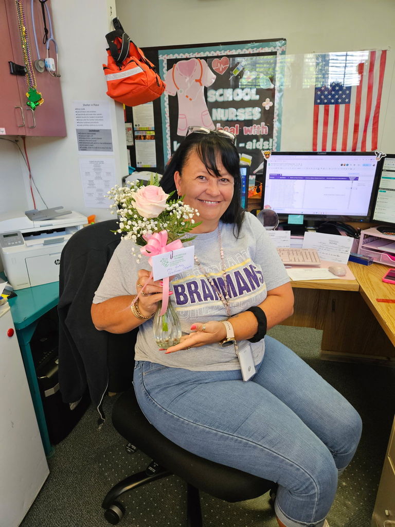 female school member with pink rose