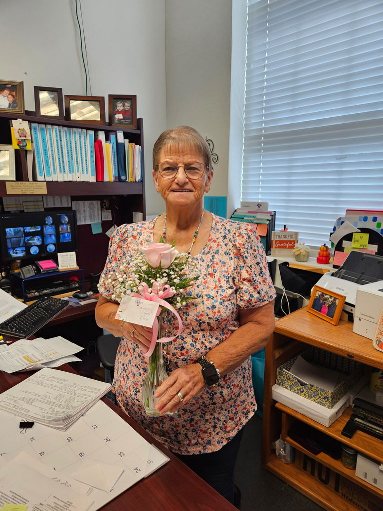 female school member with pink rose