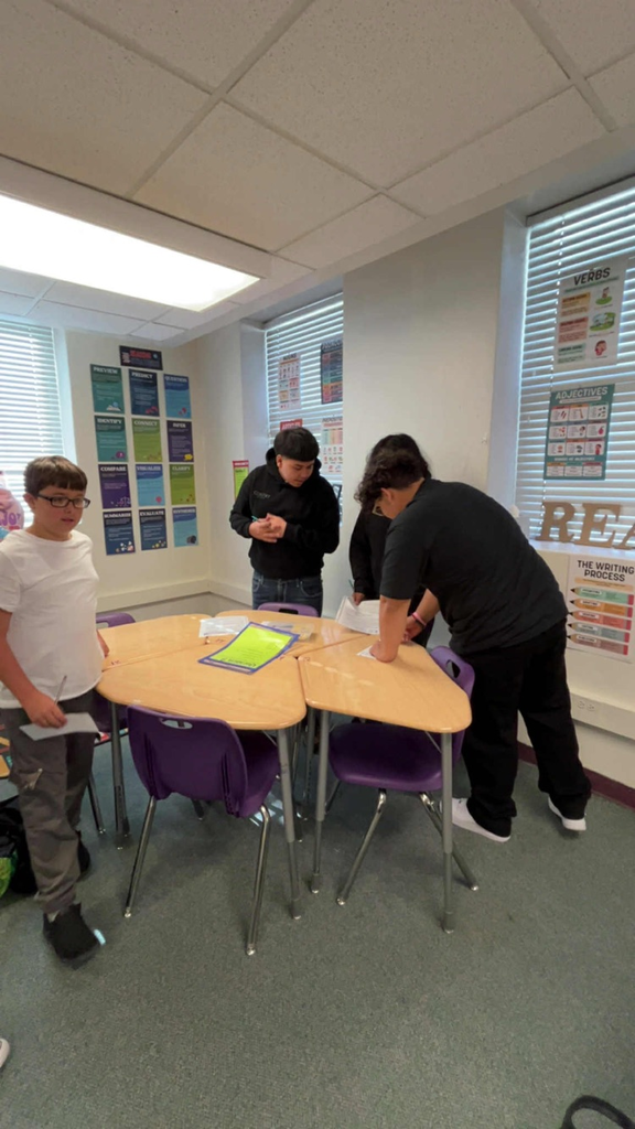 four students doing English activity in classroom