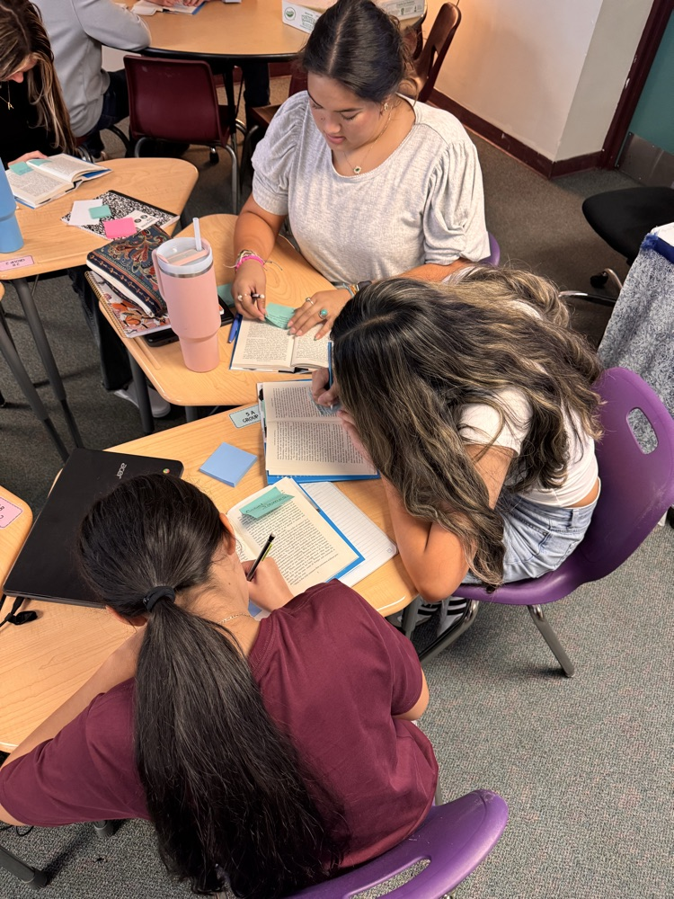 three students text marking in English class