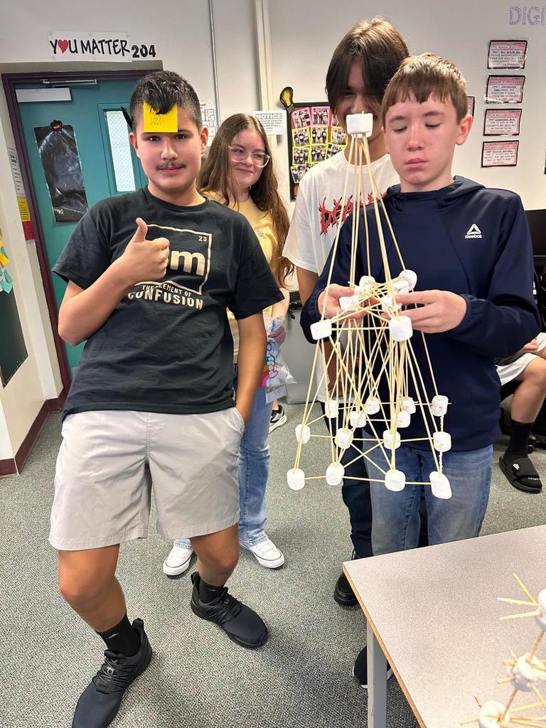 four students holding marshmallow project in digital tech class