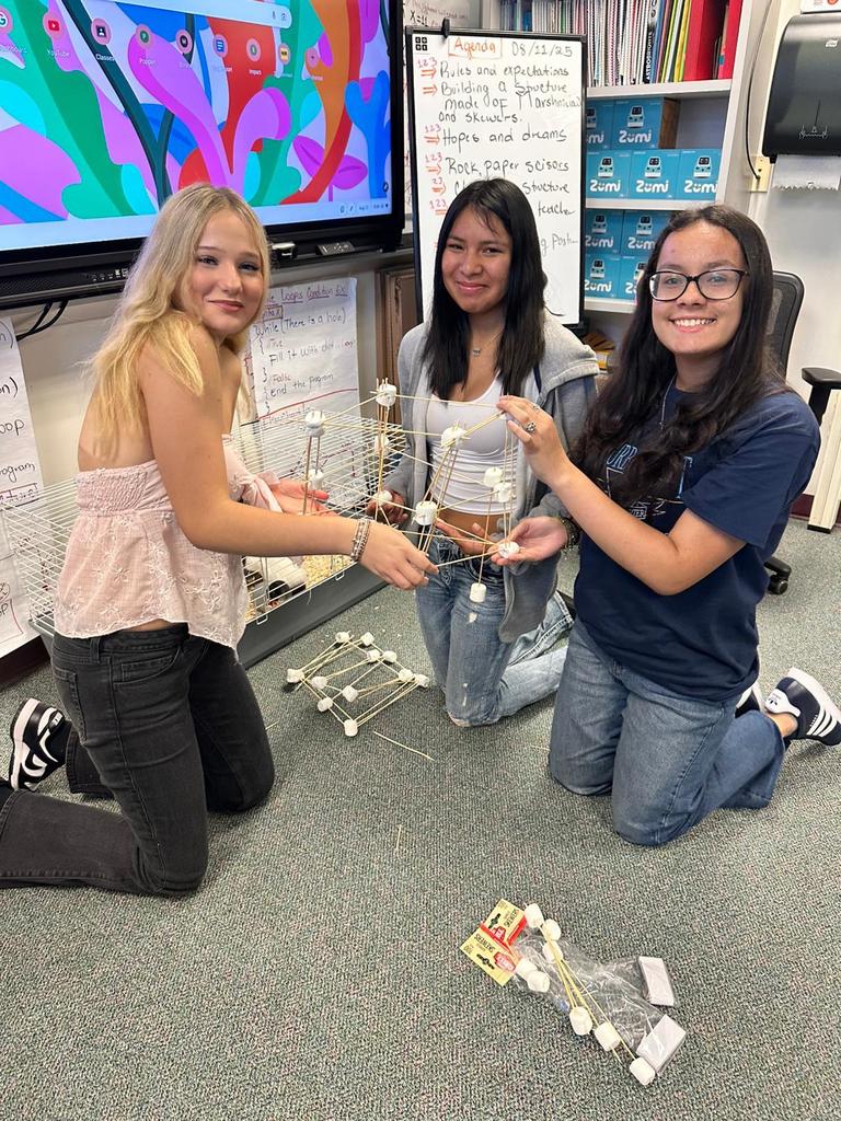 three students working on marshmallow project in digital tech