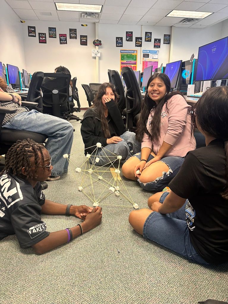 students on floor of digital tech class working on marshmallow project