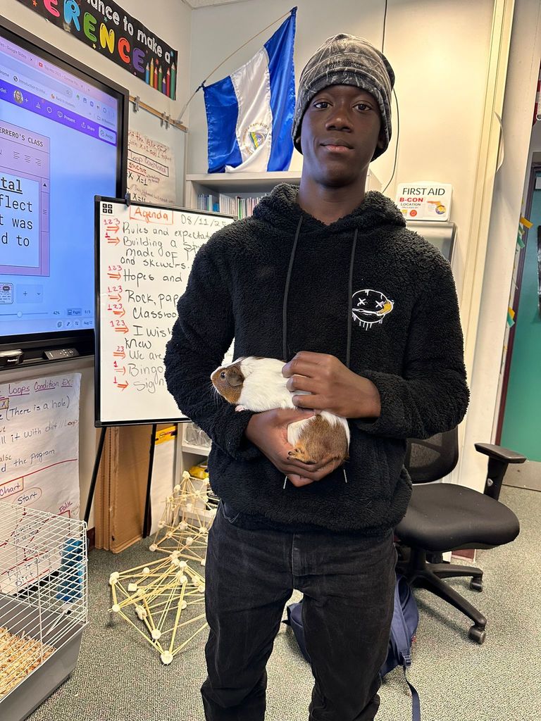 student holding guinea pig
