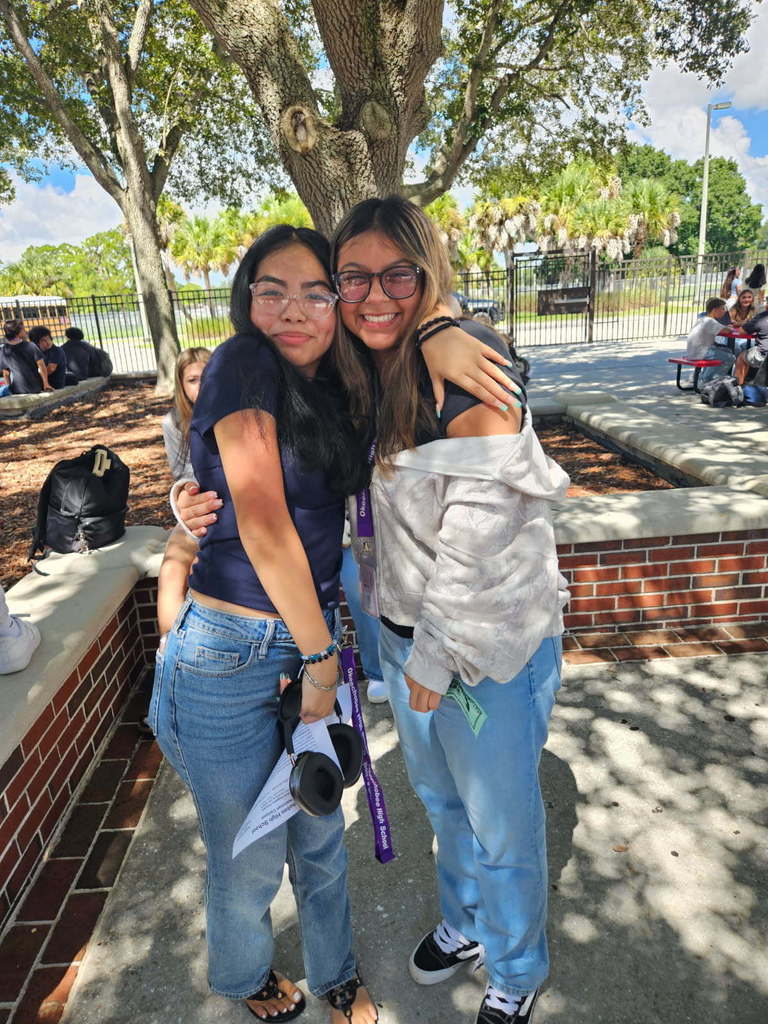 two girls hugging in courtyard