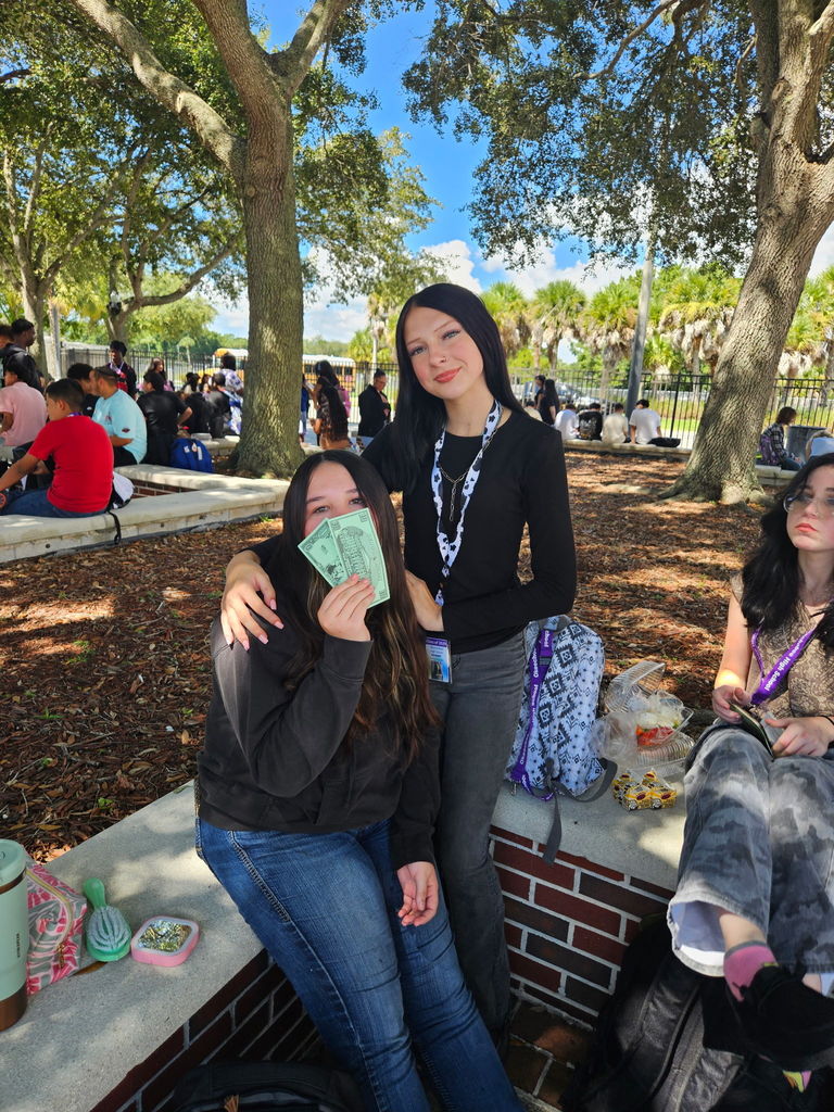 two girls sitting in courtyard at school