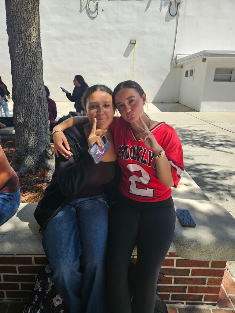 two girls sitting in courtyard at school