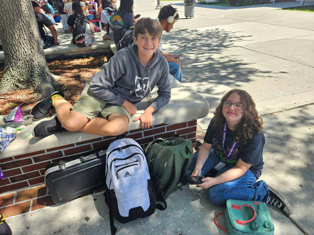 boy and girl sitting in courtyard during lunch
