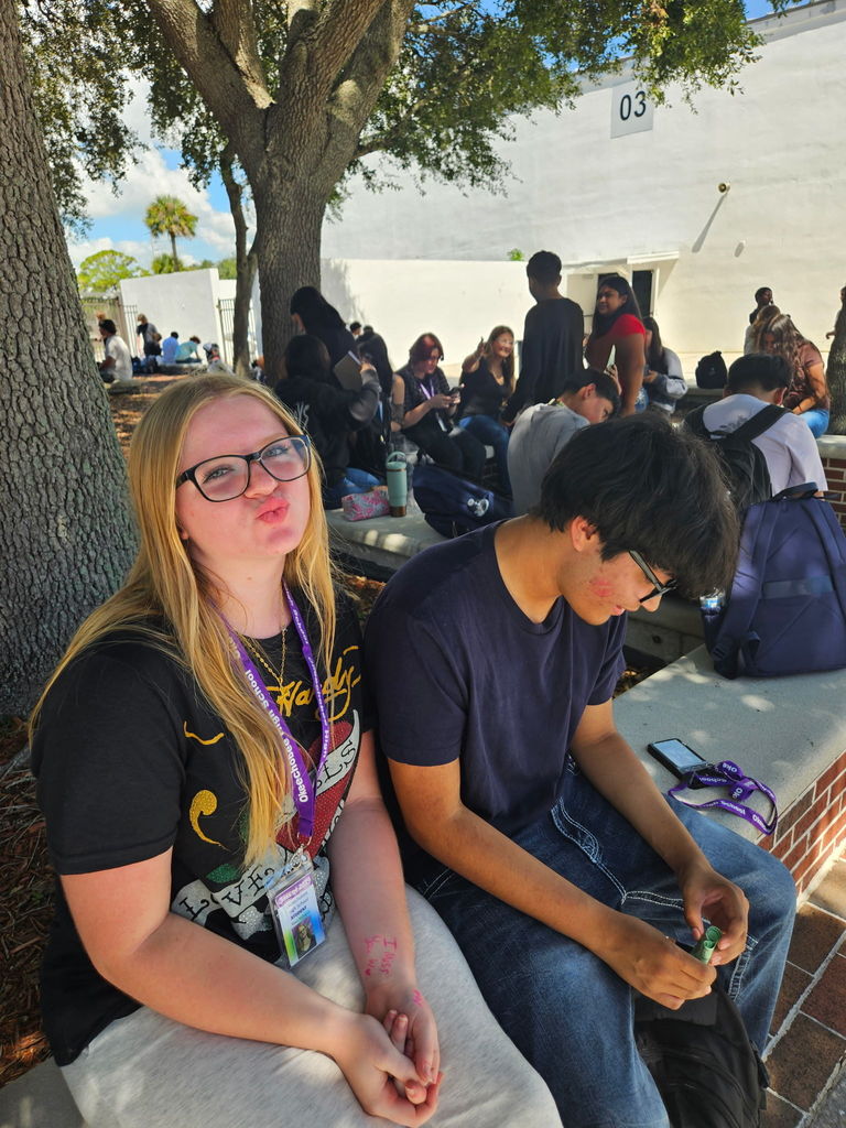 two students sitting in courtyard during lunch