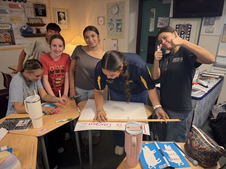 six students working on poster for English class